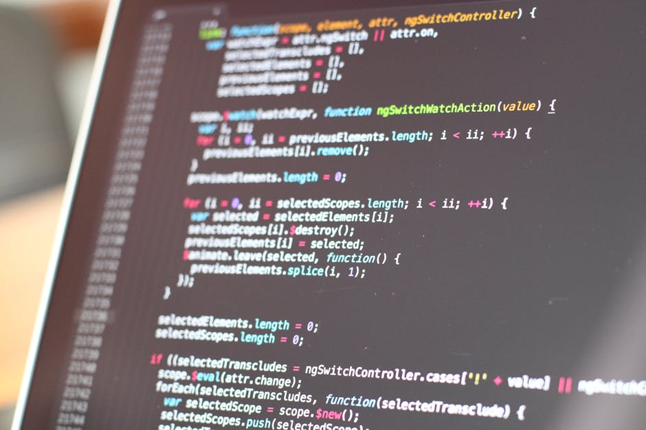A close-up view of a computer screen displaying lines of colorful code, including syntax highlighting in green, pink, blue, and yellow. The code appears to be JavaScript and is slightly blurred, with 