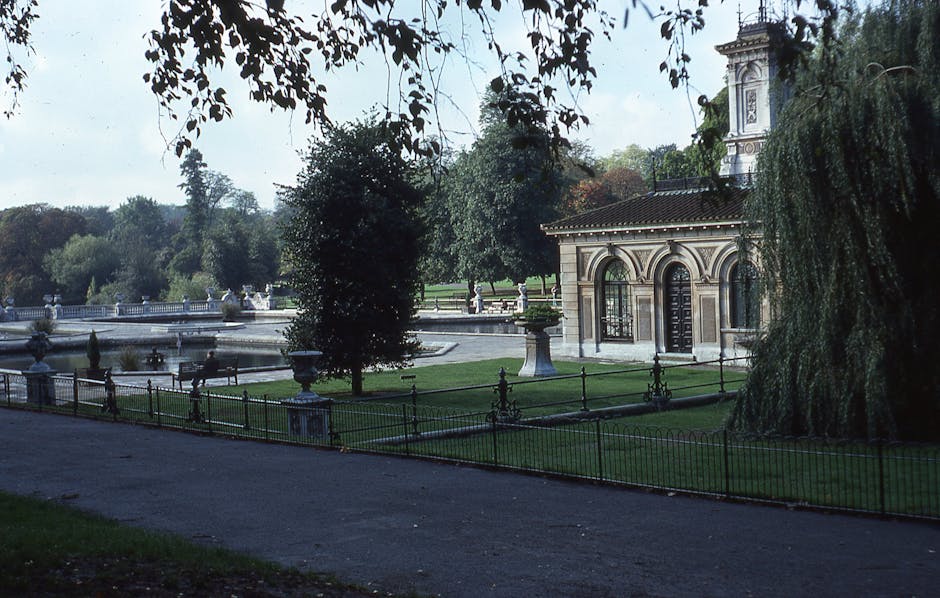 A gardening specialist from the company is working outdoors in a well-maintained garden at Crystal Palace Park, focusing on landscape maintenance for Gipsy Hill homes. The scene shows a lush green law